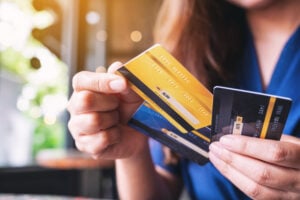 Closeup image of a woman holding and choosing credit card to use