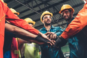 Skillful worker stand together showing teamwork in the factory .